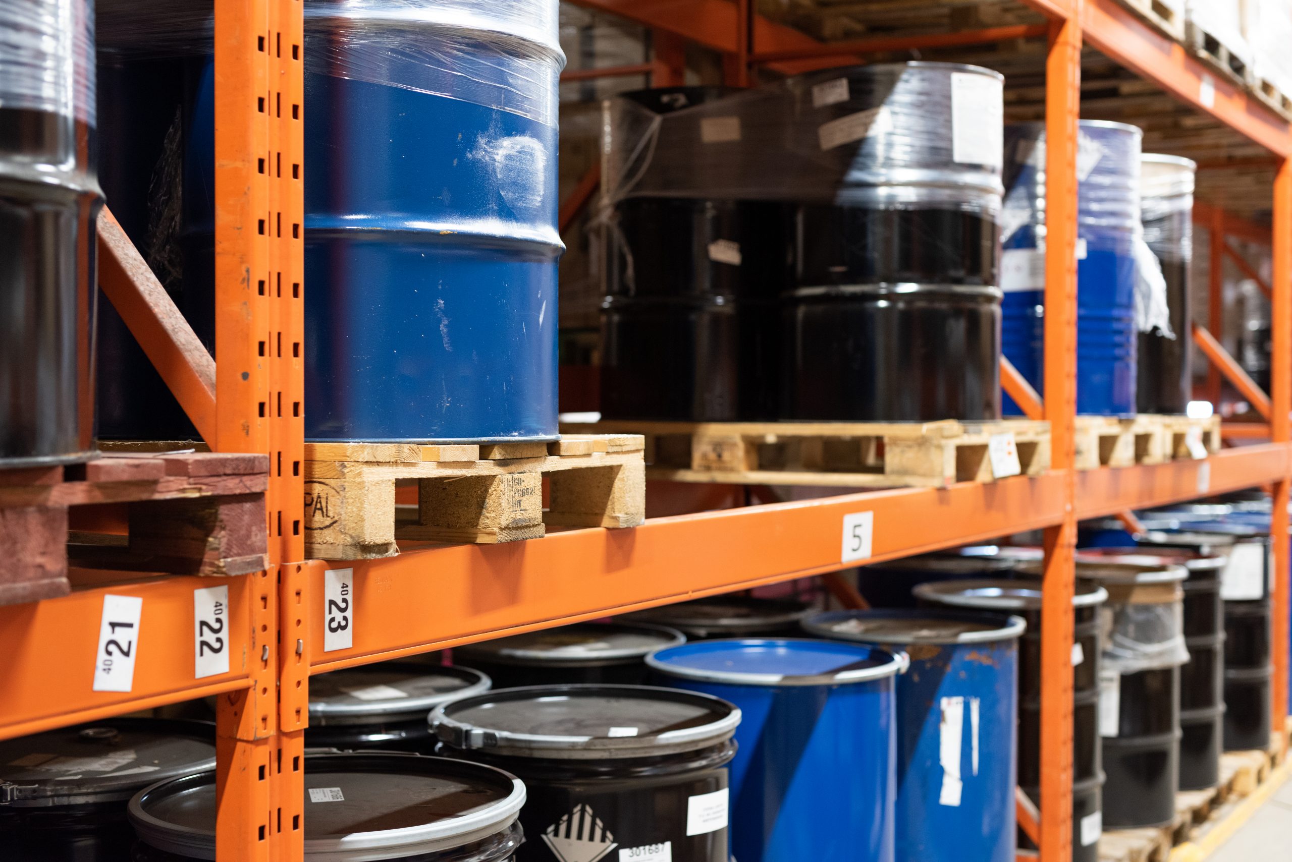 Chemical barrels stacked in a warehouse | Cedesa